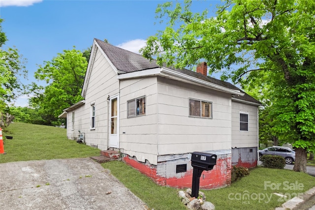 117 Young Ave SW, Concord, NC 28025 - view of property exterior with a chimney, a lawn, and roof with shingles