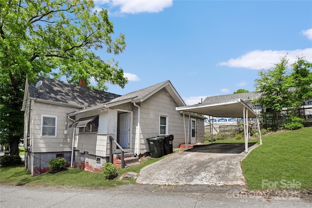 117 Young Ave SW, Concord, NC 28025 - view of front of house with a front yard, driveway, a chimney, entry steps, and a detached carport