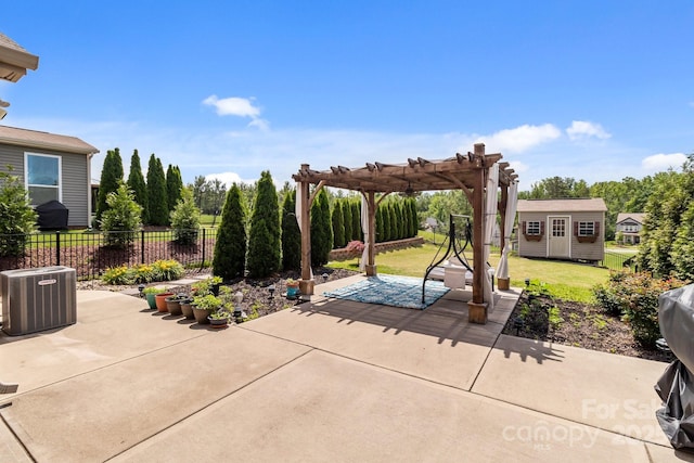 2835 Berkhamstead Cir, Concord, NC 28027 - view of patio featuring central AC, a pergola, and an outbuilding
