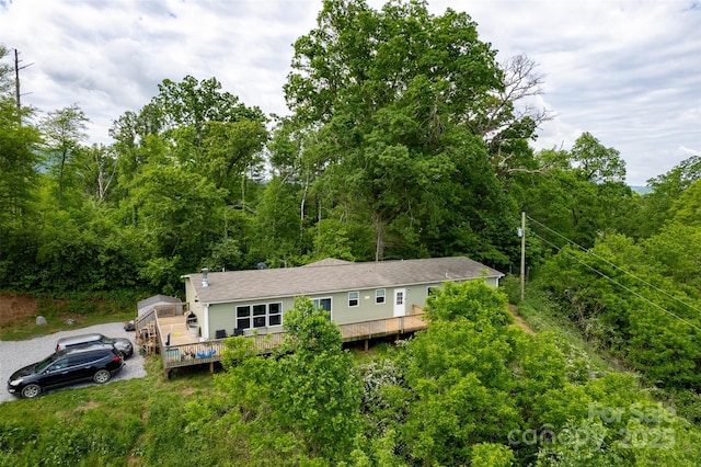 view of subject property featuring a heavily wooded area