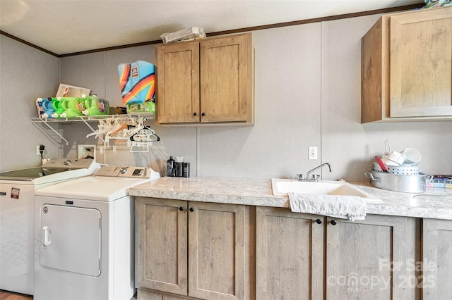 washroom with washer and dryer, cabinet space, and crown molding