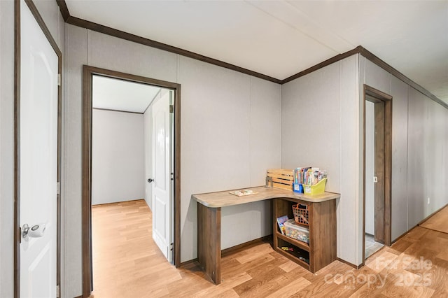 hall with crown molding and light wood finished floors