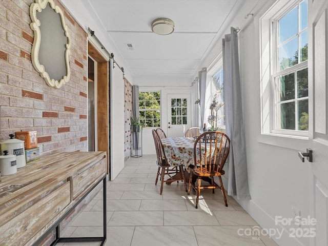 sunroom / solarium featuring a barn door