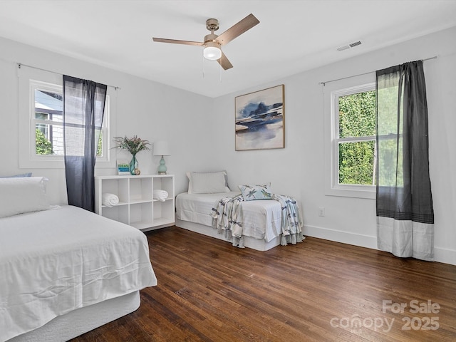 bedroom featuring wood finished floors, baseboards, and ceiling fan