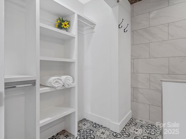 spacious closet featuring tile patterned floors