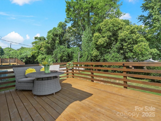 deck featuring outdoor dining area