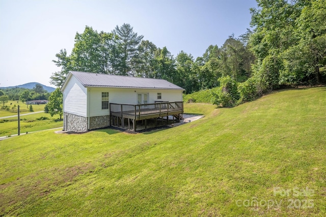 905 Severt Cir, Lenoir, NC 28645 - back of property featuring a wooden deck, a lawn, stone siding, and metal roof
