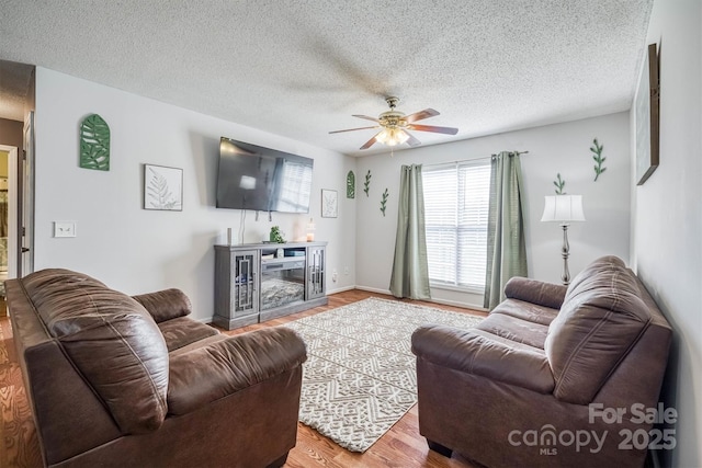 905 Severt Cir, Lenoir, NC 28645 - living room with wood finished floors, a ceiling fan, and a textured ceiling