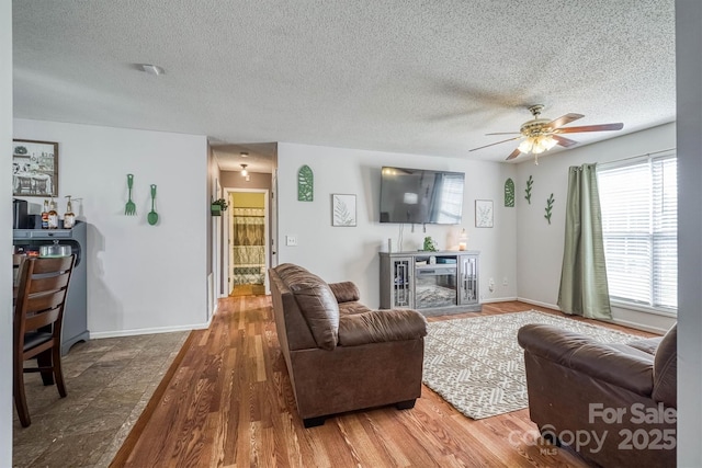 905 Severt Cir, Lenoir, NC 28645 - living room with ceiling fan, wood finished floors, a textured ceiling, and baseboards