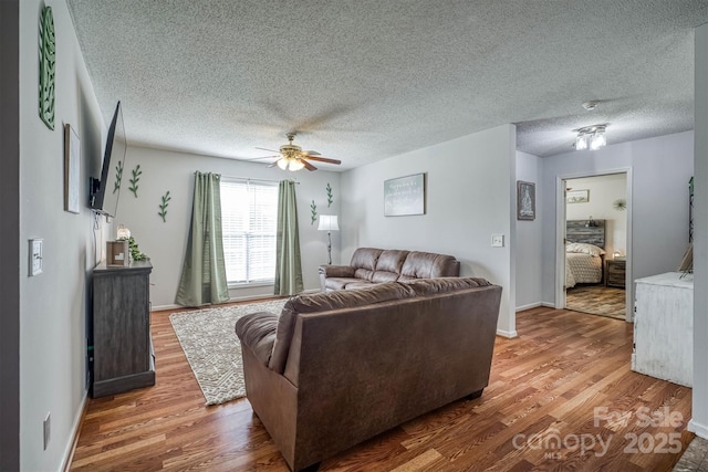 905 Severt Cir, Lenoir, NC 28645 - living area with wood finished floors, a ceiling fan, baseboards, and a textured ceiling