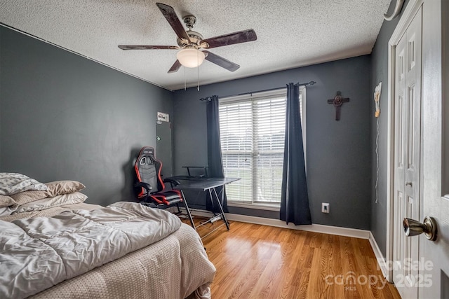 905 Severt Cir, Lenoir, NC 28645 - bedroom with a textured ceiling, light wood finished floors, baseboards, and ceiling fan