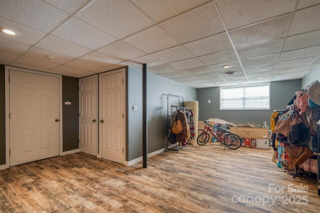 905 Severt Cir, Lenoir, NC 28645 - basement featuring wood finished floors, a paneled ceiling, and baseboards