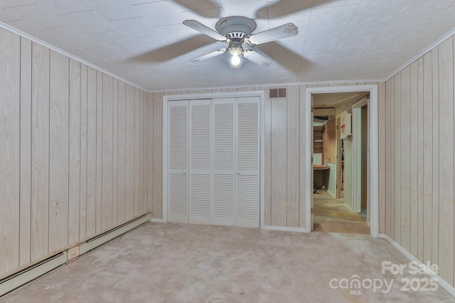 466 Shiloh Church Rd, Hickory, NC 28601 - unfurnished bedroom featuring baseboard heating, wood walls, carpet flooring, a closet, and crown molding