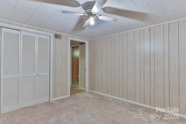 466 Shiloh Church Rd, Hickory, NC 28601 - unfurnished bedroom with wooden walls, a closet, carpet flooring, a ceiling fan, and ornamental molding