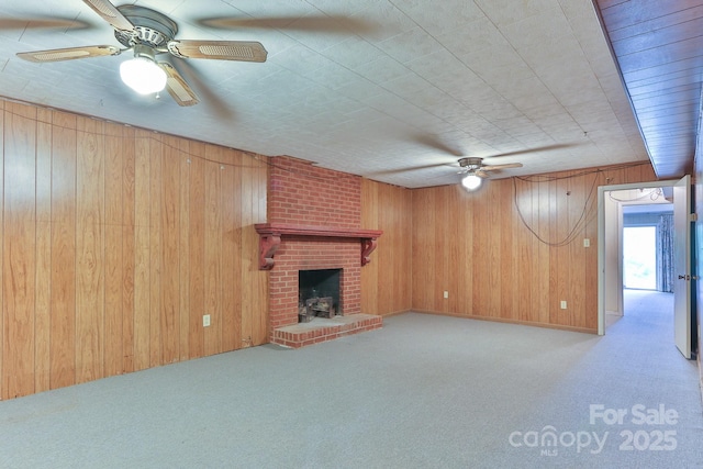 466 Shiloh Church Rd, Hickory, NC 28601 - unfurnished living room featuring wood walls, carpet floors, ceiling fan, and a fireplace