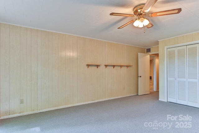 466 Shiloh Church Rd, Hickory, NC 28601 - unfurnished bedroom featuring carpet flooring, crown molding, a closet, ceiling fan, and wooden walls