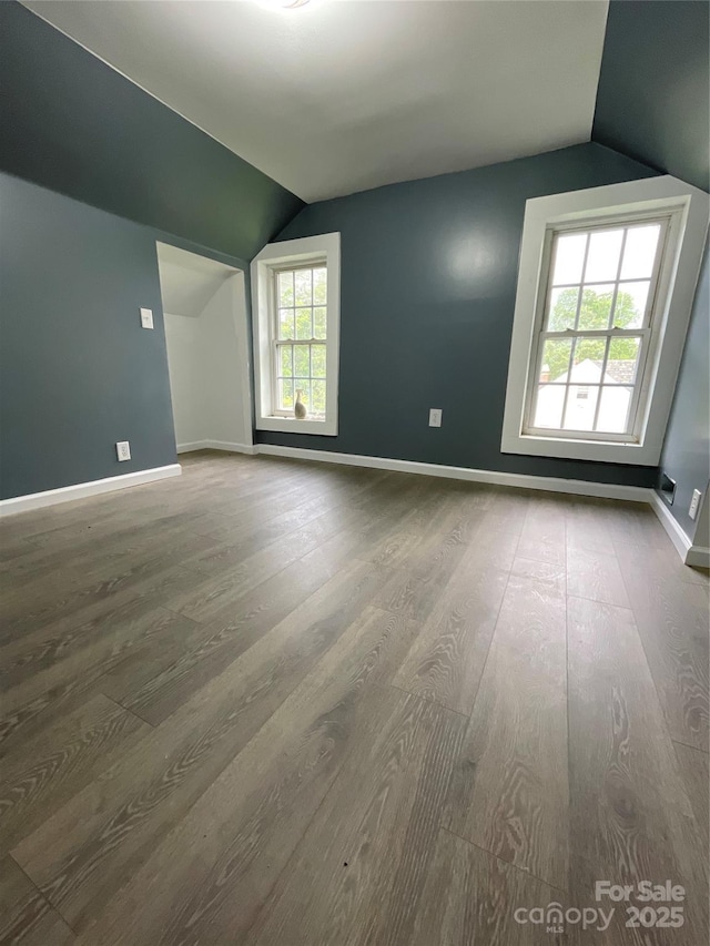 836 Mccreary St, Winston Salem, NC 27105 - additional living space featuring lofted ceiling, wood finished floors, and baseboards