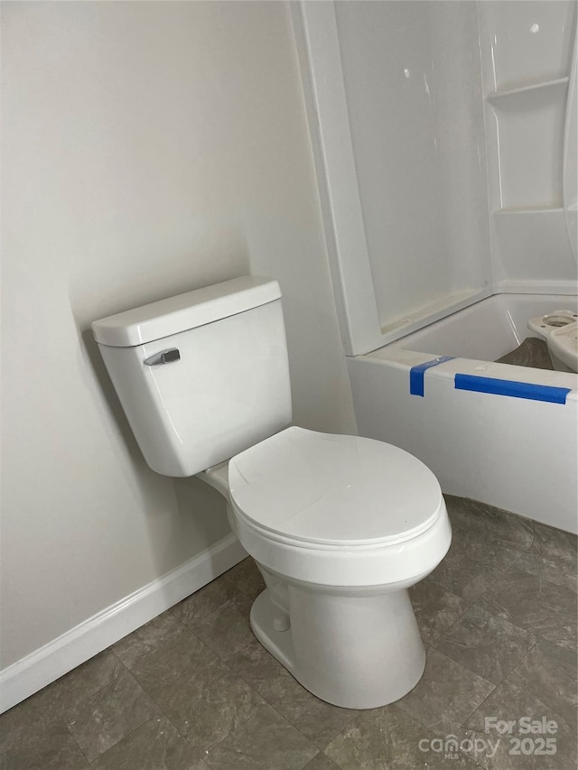 836 Mccreary St, Winston Salem, NC 27105 - bathroom featuring toilet, baseboards, and shower / bathtub combination