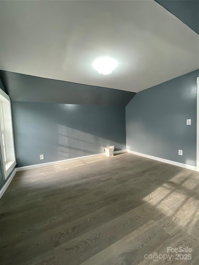 836 Mccreary St, Winston Salem, NC 27105 - empty room featuring vaulted ceiling, wood finished floors, and baseboards