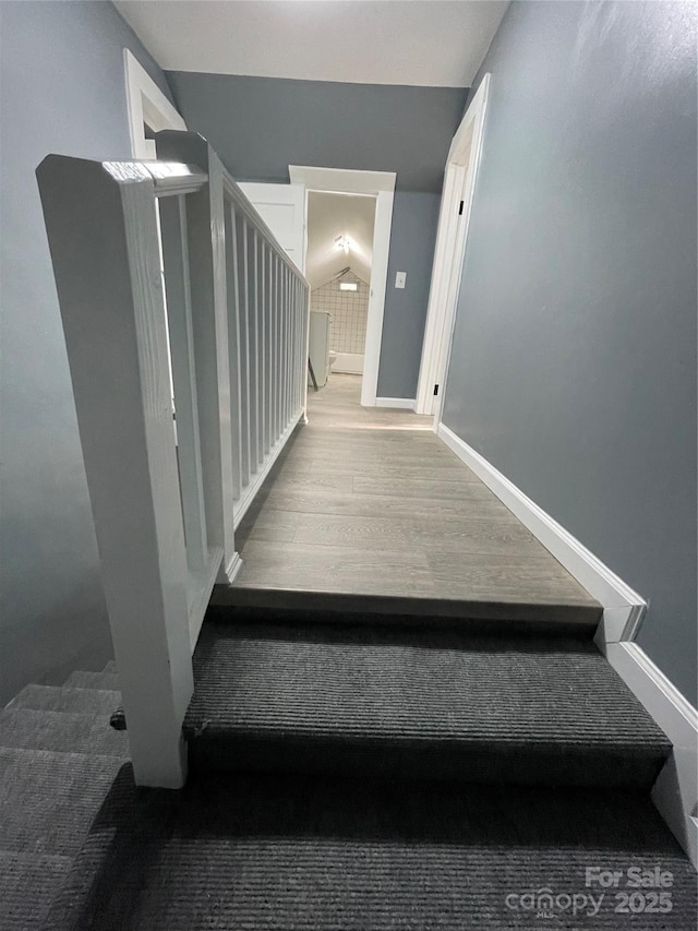 836 Mccreary St, Winston Salem, NC 27105 - stairs featuring wood finished floors, vaulted ceiling, and baseboards