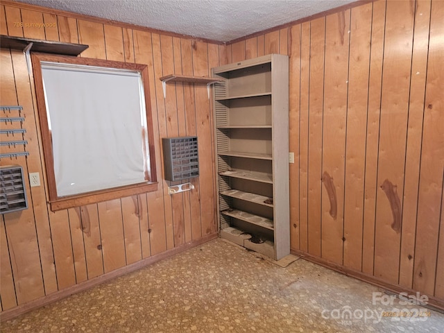 7608 Surreywood Pl, Charlotte, NC 28270 - unfurnished bedroom featuring wood walls and a textured ceiling