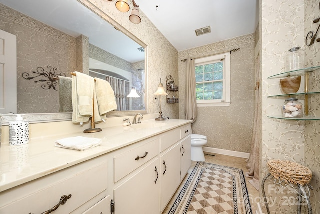 4630 Woodleaf Rd, Salisbury, NC 28147 - bathroom with toilet, wallpapered walls, vanity, and tile patterned flooring