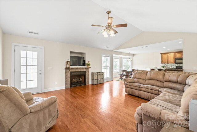8717 Swift Rd, Oakboro, NC 28129 - living area featuring ceiling fan, light wood finished floors, vaulted ceiling, a fireplace, and baseboards