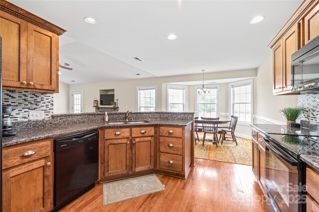 8717 Swift Rd, Oakboro, NC 28129 - kitchen with black appliances, a sink, brown cabinets, light wood finished floors, and recessed lighting