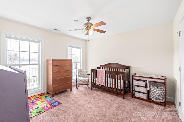 8717 Swift Rd, Oakboro, NC 28129 - bedroom featuring carpet floors, ceiling fan, a nursery area, and baseboards