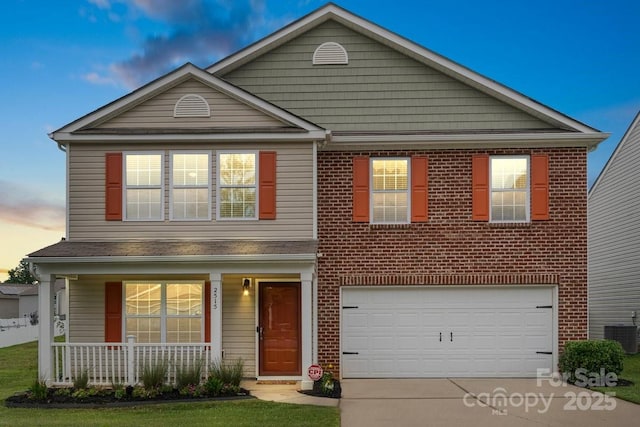 2515 Walnut Forest Dr, Charlotte, NC 28216 - traditional-style home with covered porch, driveway, an attached garage, cooling unit, and brick siding