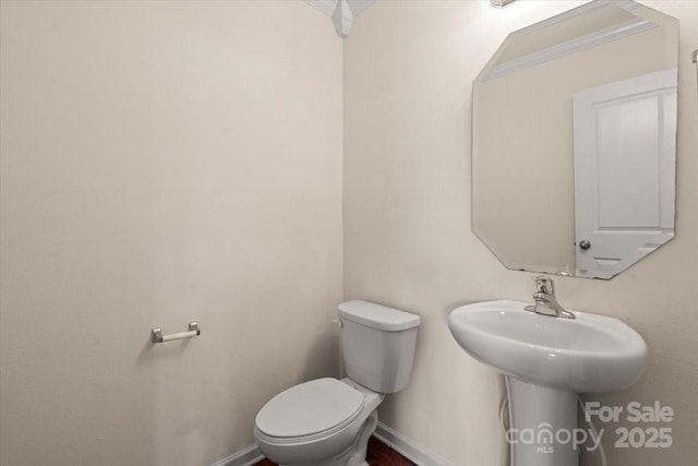 2515 Walnut Forest Dr, Charlotte, NC 28216 - half bathroom featuring toilet and baseboards