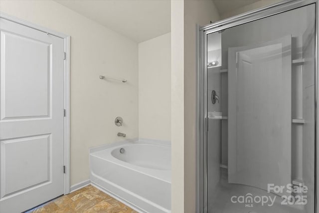 2515 Walnut Forest Dr, Charlotte, NC 28216 - bathroom featuring a shower stall, a garden tub, and baseboards
