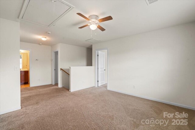 2515 Walnut Forest Dr, Charlotte, NC 28216 - empty room featuring attic access, light colored carpet, ceiling fan, and a smoke detector