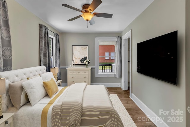 111 E Church St, Stanley, NC 28164 - bedroom featuring multiple windows, wood finished floors, baseboards, and a ceiling fan