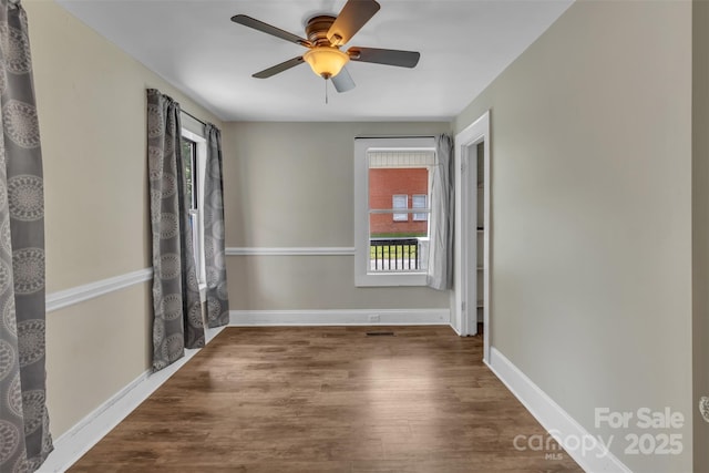 111 E Church St, Stanley, NC 28164 - unfurnished room with healthy amount of natural light, wood finished floors, baseboards, and a ceiling fan