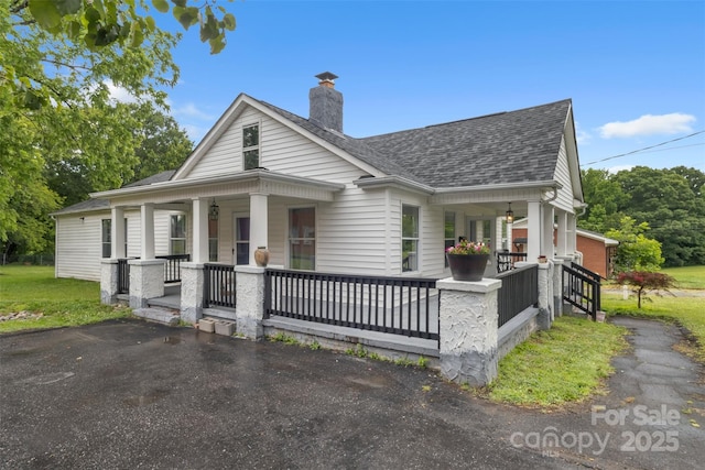 111 E Church St, Stanley, NC 28164 - view of front of house featuring covered porch, a shingled roof, and a chimney