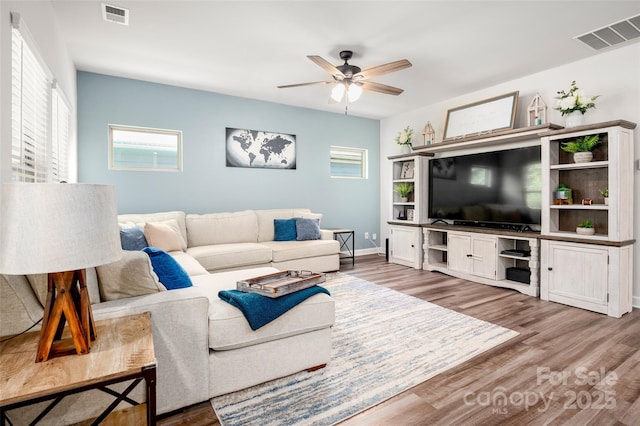 7530 Porrera St, Charlotte, NC 28214 - living room with wood finished floors and ceiling fan