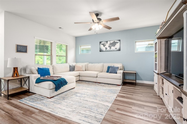7530 Porrera St, Charlotte, NC 28214 - living room featuring healthy amount of natural light, ceiling fan, and light wood-style floors