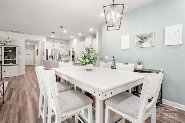 7530 Porrera St, Charlotte, NC 28214 - dining room featuring light wood-style flooring, a chandelier, and recessed lighting