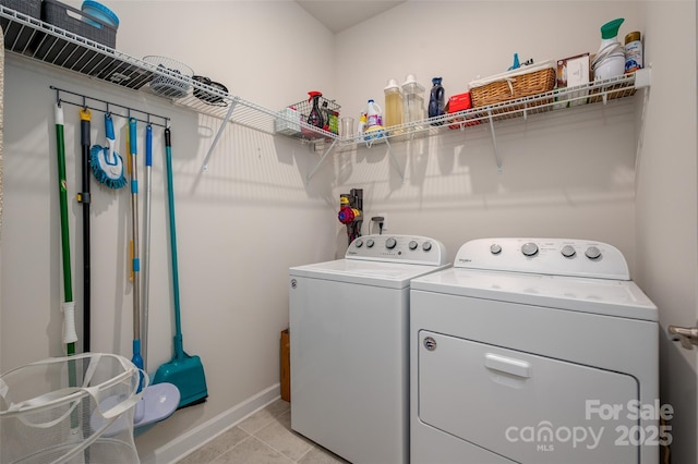 7530 Porrera St, Charlotte, NC 28214 - laundry area with washing machine and dryer and light tile patterned floors