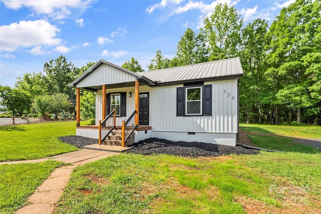 modern farmhouse style home with crawl space, a front lawn, metal roof, and a porch