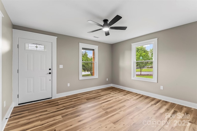 entrance foyer with light wood-style flooring, baseboards, and a ceiling fan