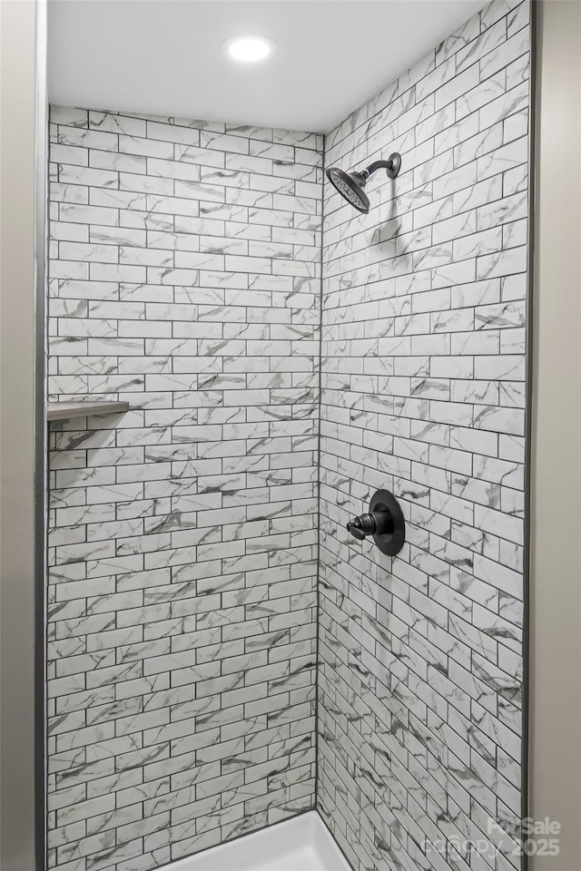 full bath featuring a tile shower and recessed lighting
