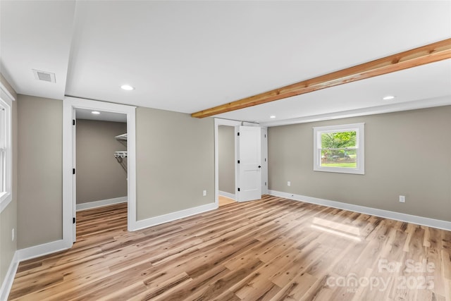 below grade area featuring light wood finished floors, baseboards, and recessed lighting