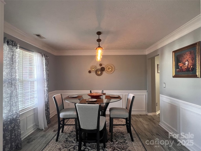 5227 Eagle Creek Dr, Charlotte, NC 28269 - dining space with wood finished floors, healthy amount of natural light, ornamental molding, a decorative wall, and a wainscoted wall