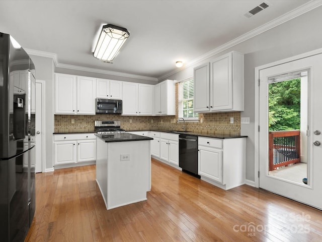 3038 Sterling Ct, Fort Mill, SC 29707 - kitchen featuring stainless steel appliances, a sink, light wood-type flooring, white cabinets, and ornamental molding