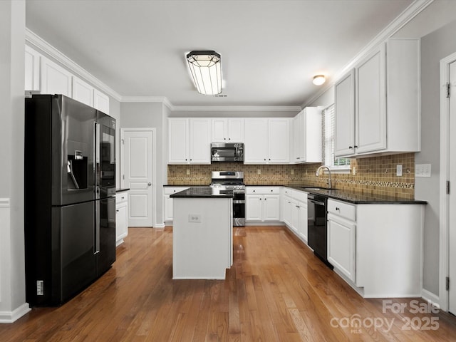 3038 Sterling Ct, Fort Mill, SC 29707 - kitchen with stainless steel appliances, a sink, dark countertops, a center island, and decorative backsplash