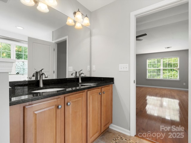 3038 Sterling Ct, Fort Mill, SC 29707 - bathroom featuring double vanity, baseboards, and hardwood / wood-style flooring