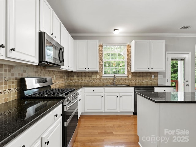 3038 Sterling Ct, Fort Mill, SC 29707 - kitchen with appliances with stainless steel finishes, a sink, white cabinetry, healthy amount of natural light, and ornamental molding