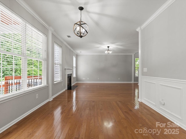 3038 Sterling Ct, Fort Mill, SC 29707 - unfurnished living room featuring a chandelier, ornamental molding, hardwood / wood-style flooring, and a fireplace with flush hearth